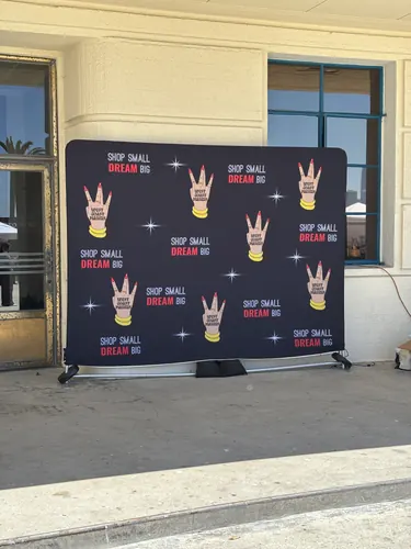 The West Coast Makers "Shop Small, Dream Big" step-and-repeat backdrop at the event entrance