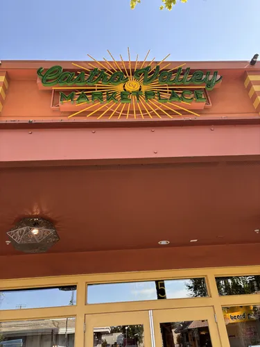 The Castro Valley Marketplace neon marquee sign above the entrance